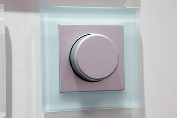 modern electric dimmer switch on wall closeup