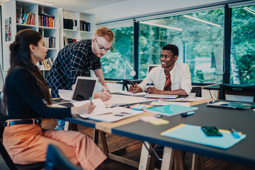 Cheerful coworkers brainstorming on new ideas
