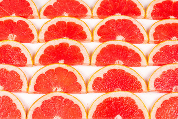 Obraz na płótnie Canvas Grapefruit red juicy slices background. top view.