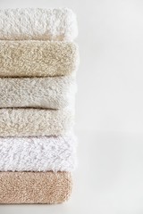 Close-up of clean cotton bath towels stacked. The concept of cleanliness and freshness. Selective...