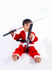 Obraz na płótnie Canvas Asian boy is wearing a Santa costume to celebrate Christmas. White background