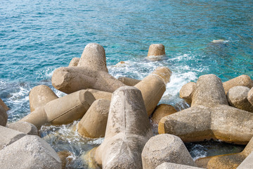 Fototapeta na wymiar Breakwater of concrete tetrapods in Amalfi coastal town.