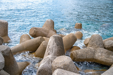 Fototapeta na wymiar Breakwater of concrete tetrapods in Amalfi coastal town.