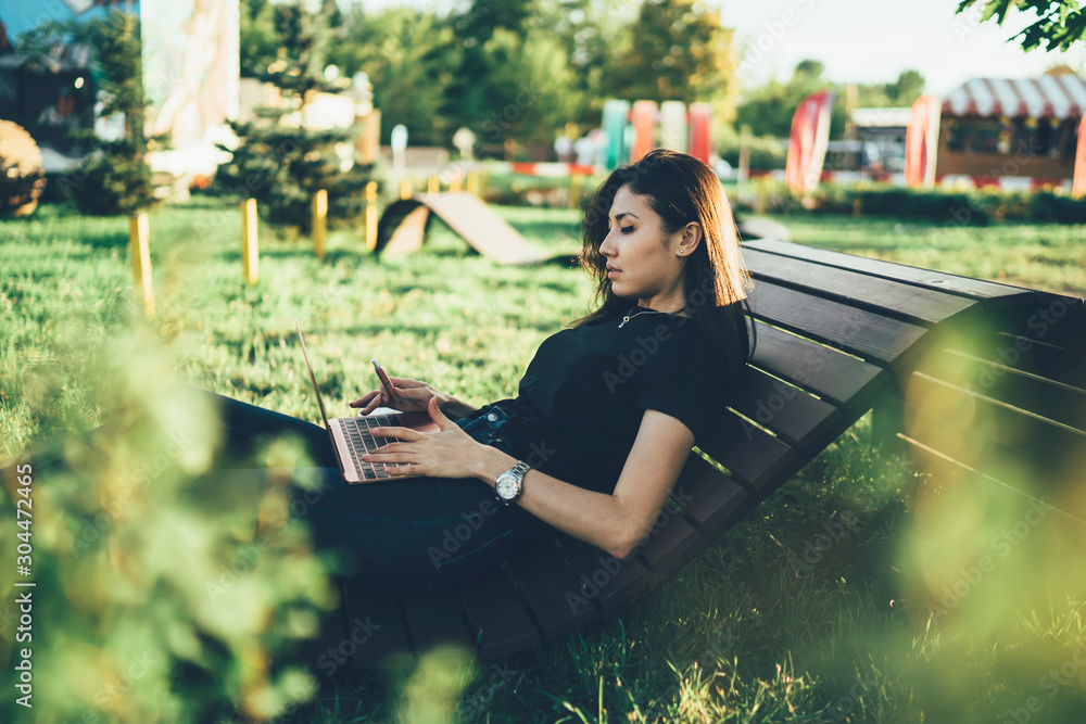 Poster asian skilled female programmer with electronic vapon in hand working remotely with new business pro