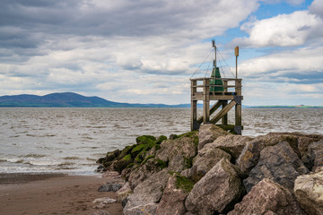 Fototapeta na wymiar The entrance to the harbour with the coast of Scotland in the background, seen from the West Beach in Silloth, Cumbria, England, UK