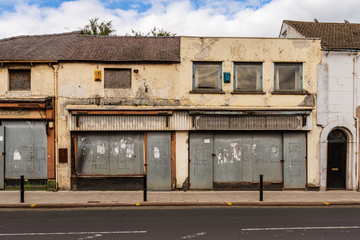 A rundown house with covered doors and windows in the ground floor, seen in Carlisle, Cumbria,...