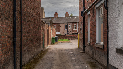 Small road into a backyard with some houses in Carlisle, Cumbria, England, UK