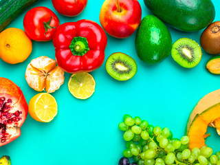 Fruits rich in antioxidants, vitamin and fiber on blue background. Flat lay. Raw, vegan, vegetarian, alkaline food concept.
