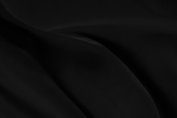 Black gray satin dark fabric texture luxurious shiny that is abstract silk cloth background with patterns soft waves blur beautiful.