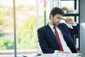 Businessman working in office with desktop computer and documents on his desk in action thinking using as background professional business people, successful business man consultant concept.