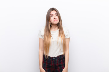 young pretty woman feeling sad and stressed, upset because of a bad surprise, with a negative,...