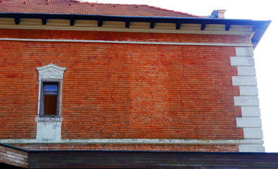 red brick wall of a house and a window
