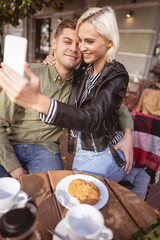 Young couple celebrating their anniversary in the cafe