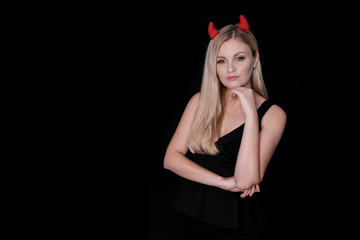 Isolated on black background devil girl with horns.