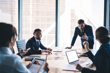 Business team actively debating during conference