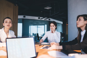 Concentrated partners reading report and communicating in business center