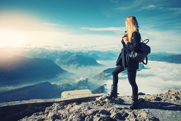 Travel tourism mountains holiday photo - Girl with backpack walking and hiking on Alps