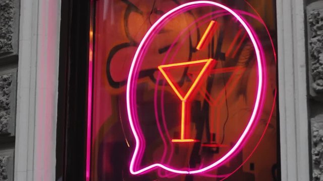 neon cocktail sign on the bar nightclub window. illuminated design drink