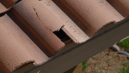 Broken roof tile in need of repair