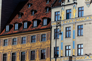 Painted facades of the famous historical buildings: House of the Seven Electors 1672 (left) and House under the blue sun (right) in the main market square of Wroclaw