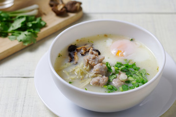 Rice porridge ,congee with minced chicken and Soft-boiled egg in white bowl