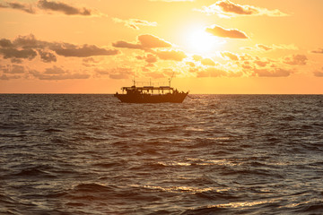 Fishing schooner at sunset