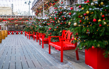 Christmas fair kiosk with loads of lovely handcrafted decorations. luxury decorated store front with garland lights in european city street at winter seasonal holidays.