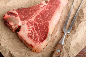 a piece of fresh farm meat t-bon non-GMO wrapped in eco-friendly wrapping paper