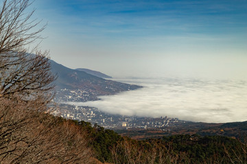 Amazing Clouds are low over the sea and creeping over the city.The view from the top.Yalta.