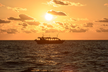 Fishing schooner at sunset