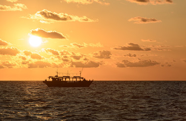 Fishing schooner at sunset