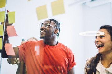 Laughing colleagues creating plan in office