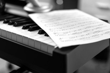 Electronic piano and musical sheet . Black and white photo, Musical Background