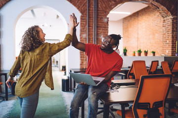 Happy diverse students giving high five
