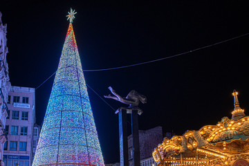 Christmas lights in Vigo, leds tree carousel and the sireno sculpture - obrazy, fototapety, plakaty