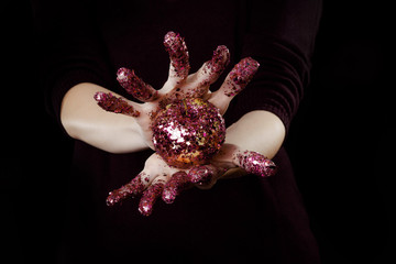 beautiful woman hands with glitter holding apple close up