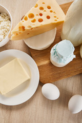 top view of various fresh organic dairy products and eggs on wooden table