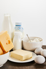 delicious fresh dairy products and eggs on wooden table isolated on white