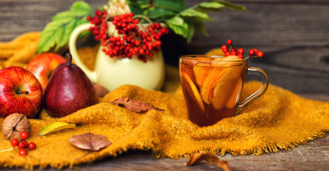 Cup of autumn tea and yellow dry leaves. Hot drink for autumn cold days. Concept autumn mood.