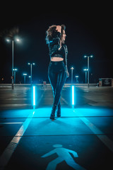 Fototapeta na wymiar Past of a young woman in an urban night session with blue lights