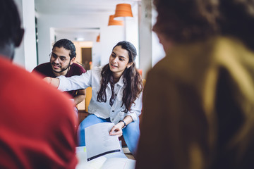 Communicating students with papers in hall