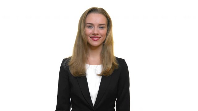 Business woman smiling into camera,potrait shot in front of white background