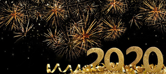 2020 golden figures standing in firework in the night