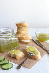 Breakfast with cucumber jam and baguette on a white background