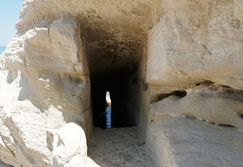 View looking inside of a man built sea cave with a view of the sea at the back