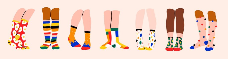 Set of seven pairs of female or male legs in the socks. Cool various prints. Stylish underwear. Fashion accessories. Footwear. Hand drawn vector colored trendy illustration. Flat design