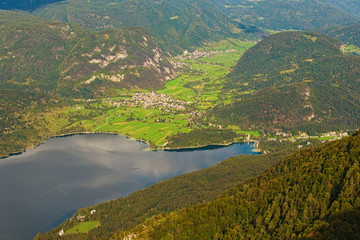 Naklejka na ściany i meble Picturesque landscape of high mountains, beautiful valley with two villages and famous Bohinj Lake (Bohinjsko jezero). Famous touristic place and travel destination in Slovenia