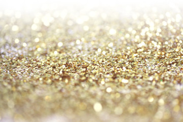 Gold (bronze) glitter shine dots confetti. Abstract light blur blink sparkle defocus backgound.