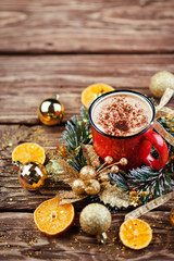 Christmas composition. Red Cup with cappuccino coffee over wooden background. Close-up with space for text.