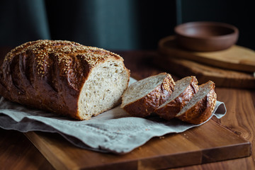 Whole grain loaf bread with chia seeds on a cutting board. Healthy eating concept.